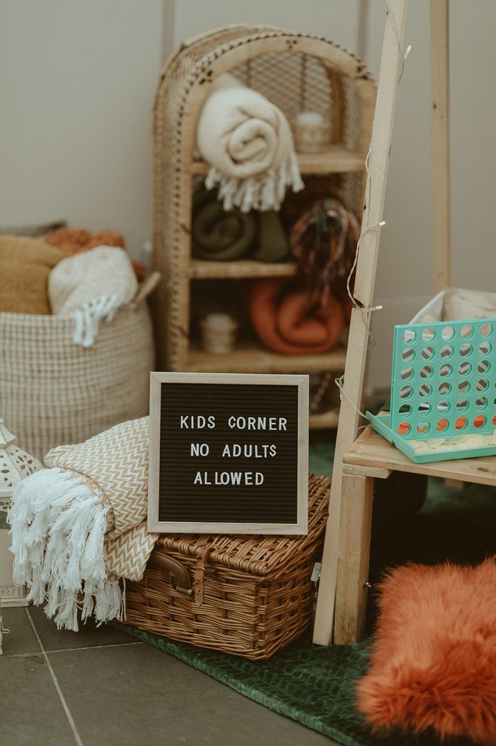 Fun kid's corner at the wedding with a 'no adults allowed' sign complete with toys, furry animals, games and blankets 