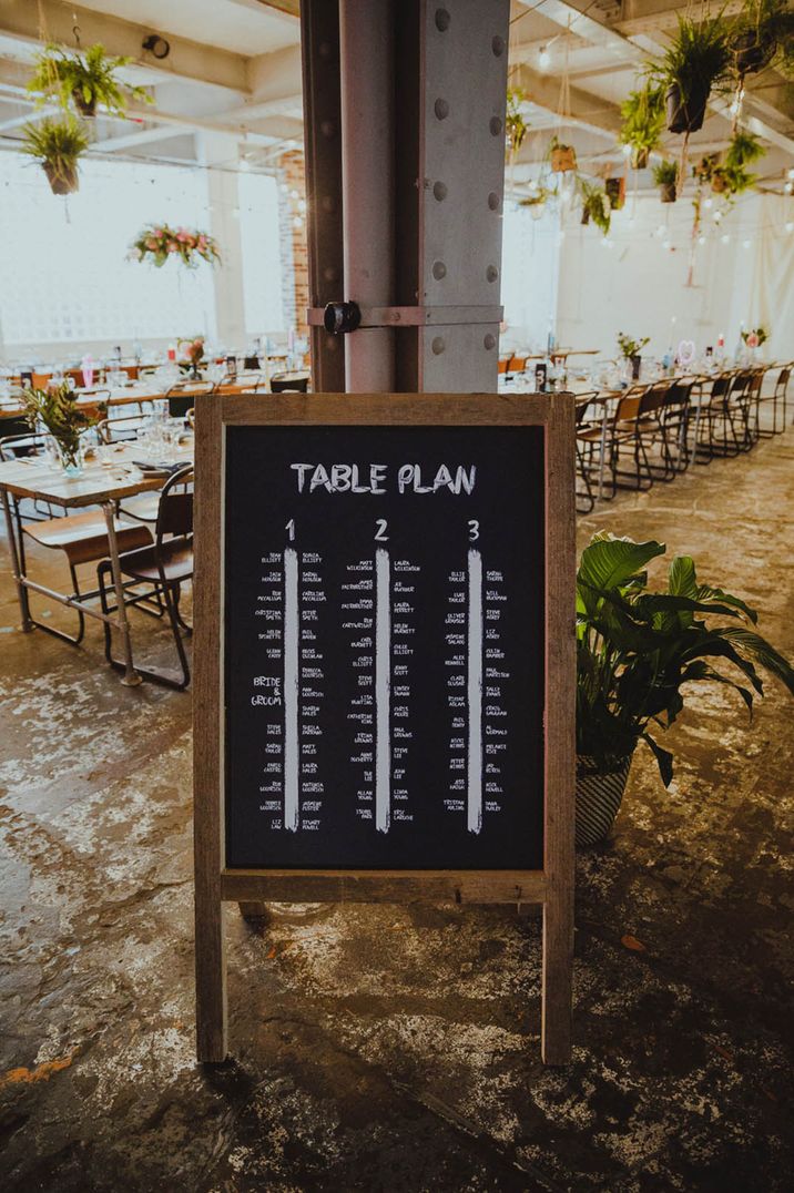 Simple and minimal chalkboard wedding table plan with wooden border 