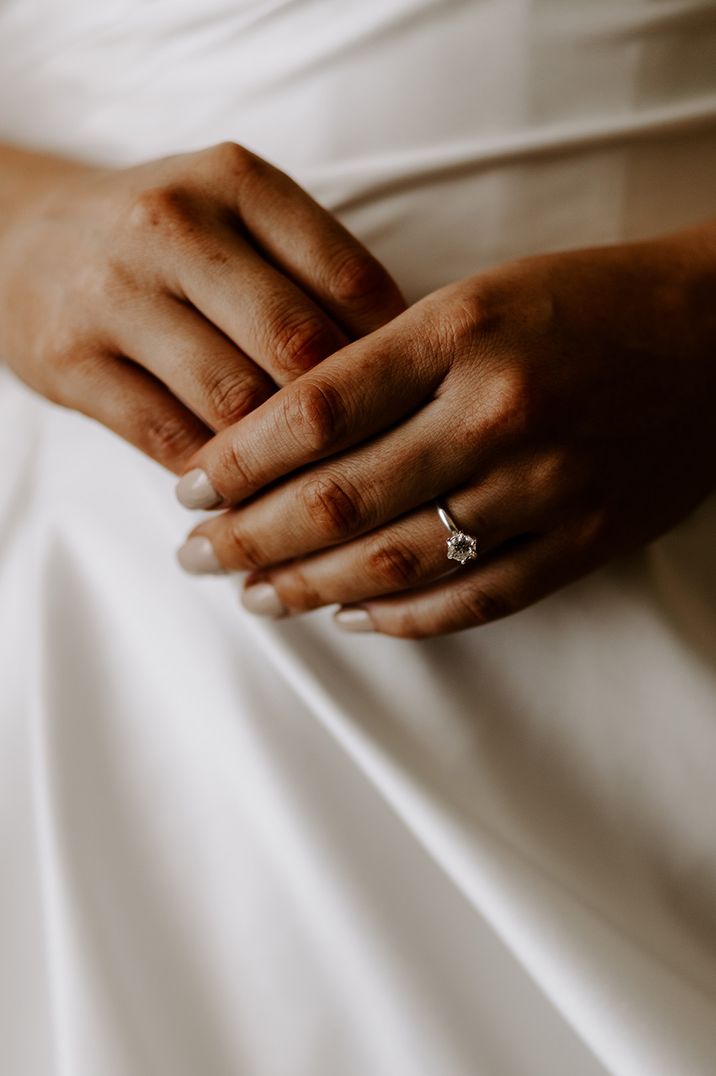 Round brilliant diamond engagement ring worn by bride 