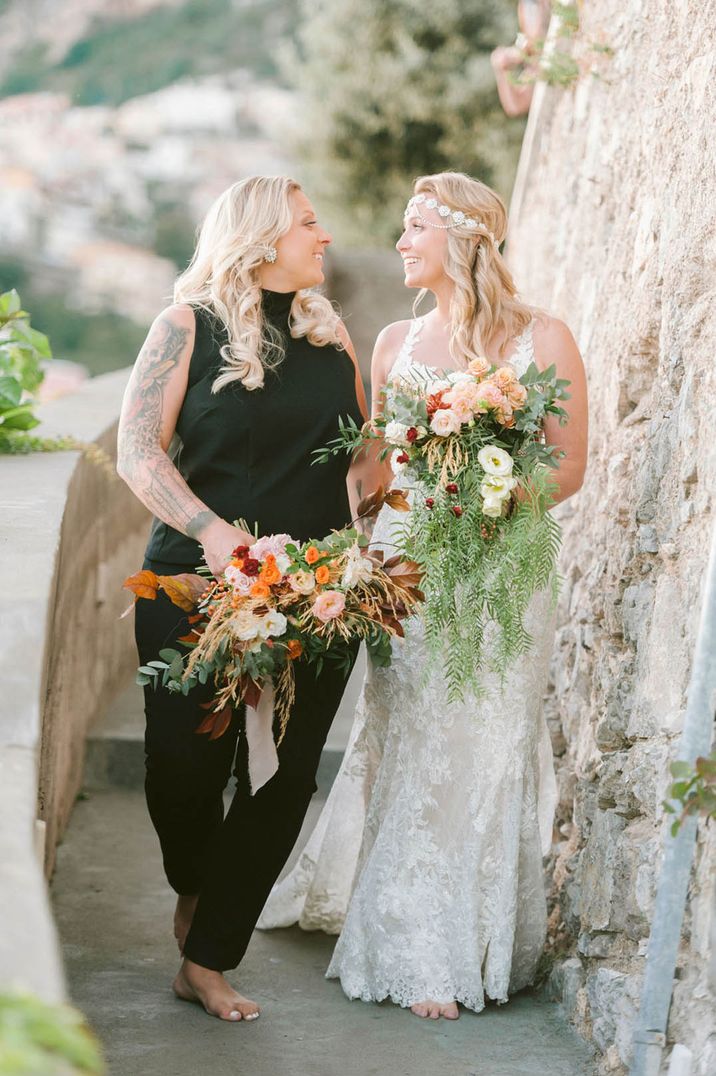 Newlyweds walking through the grounds of Hotel Marincanto after their LGBTQI+ wedding ceremony in Italy