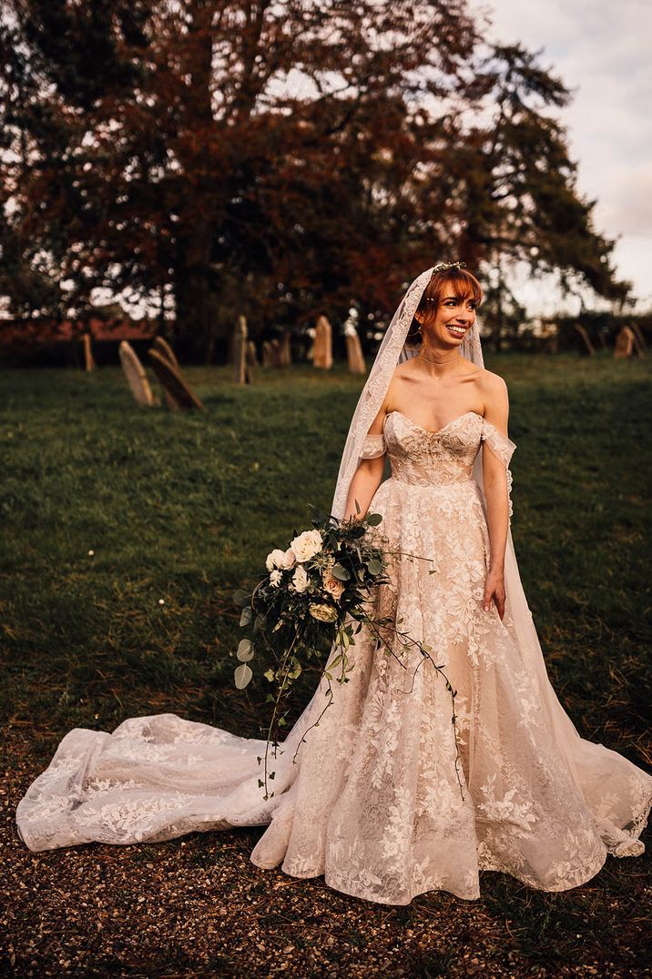 Pretty off the shoulder wedding dress with a matching embroidered edge veil 