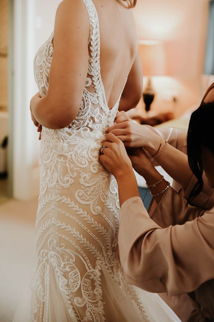 Bride wearing a delicate lace bridal outfit with a dropped waist silhouette 