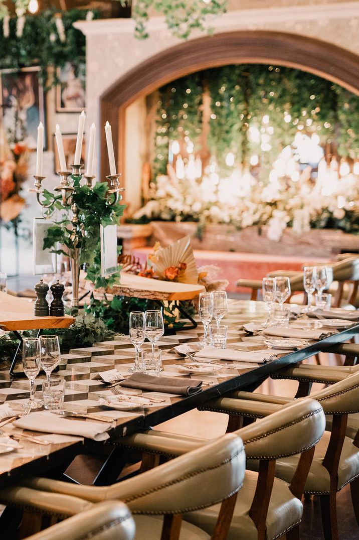 Minimalistic tablescape at Northern Ireland wedding venue with tall candelabra and foliage 