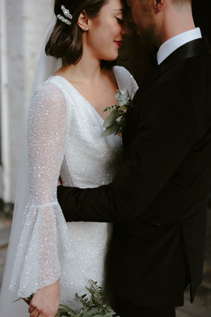 Bride in a sparkly bell long sleeve wedding dress