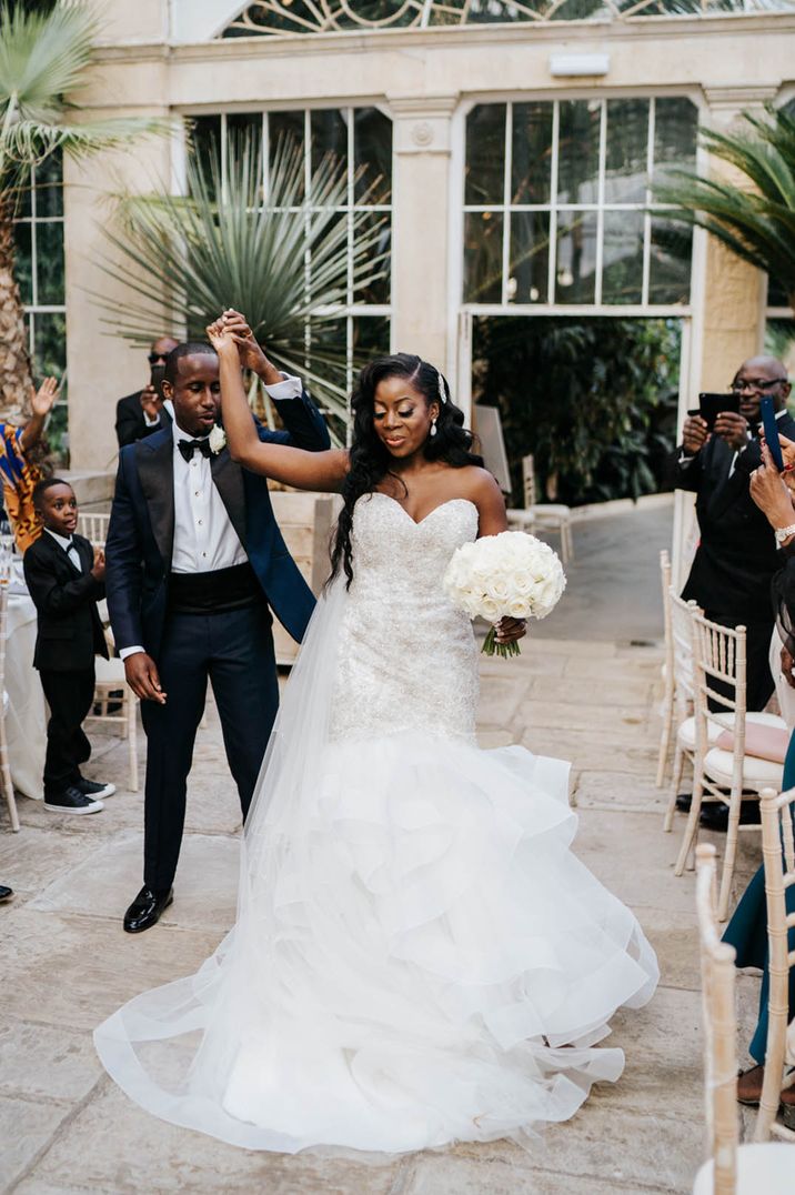 Bride in strapless wedding dress and groom dancing into their reception at Syon Park 