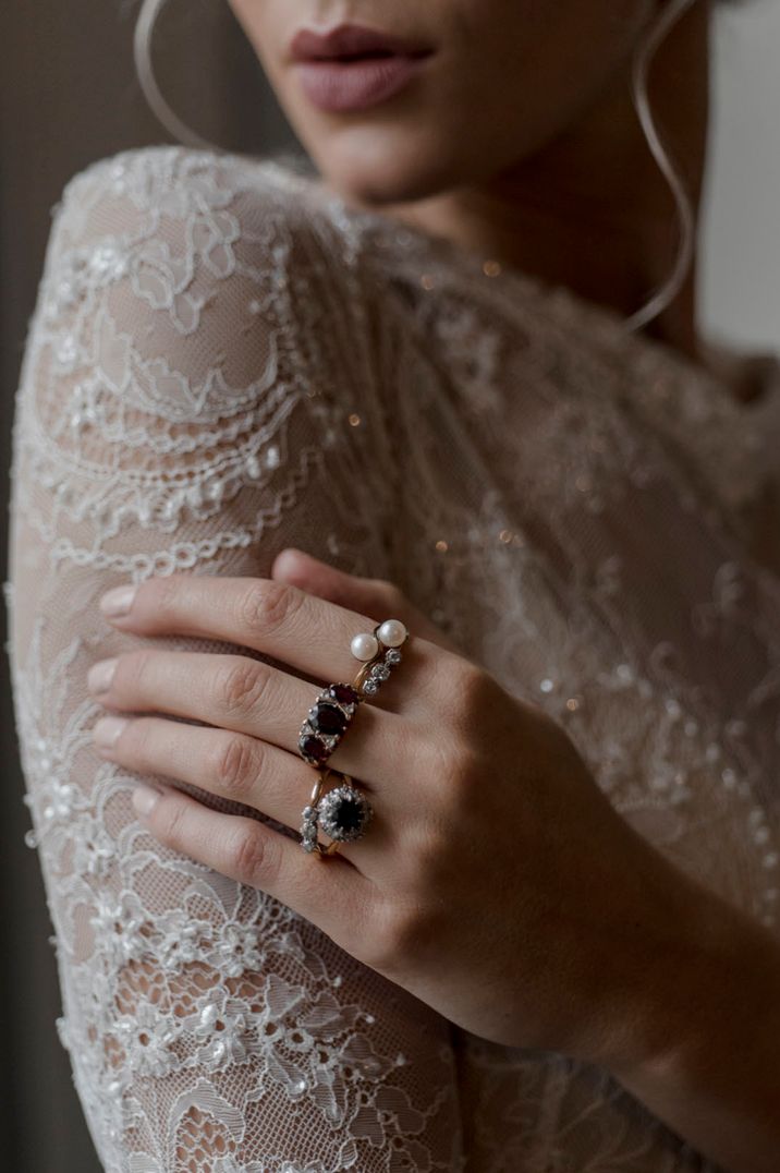 Bride wears statement rings with black stones and pearl embellishment 