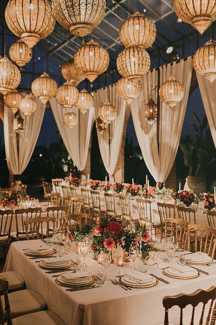 Destination wedding in Marrakech with the outdoor wedding breakfast decorated with incredible gold wedding lanterns 