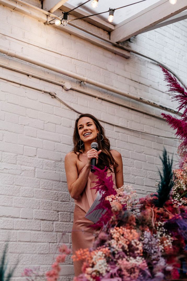 Maid of honour in peach satin full length slip dress