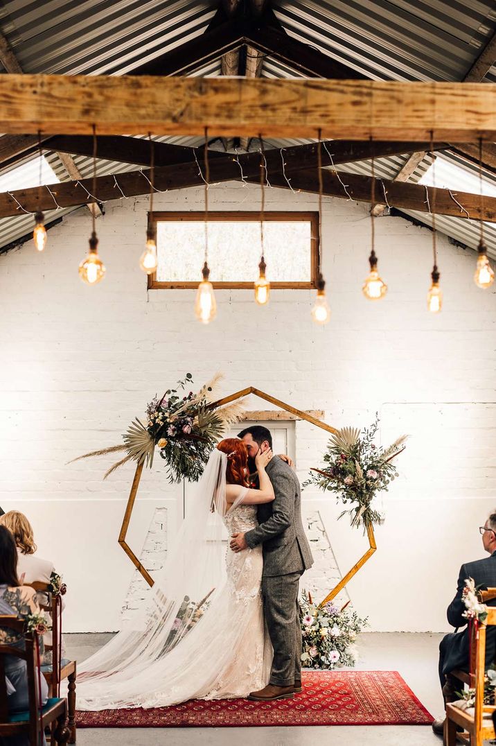 Bride and groom share their first kiss as a married couple at White Skye Fields wedding