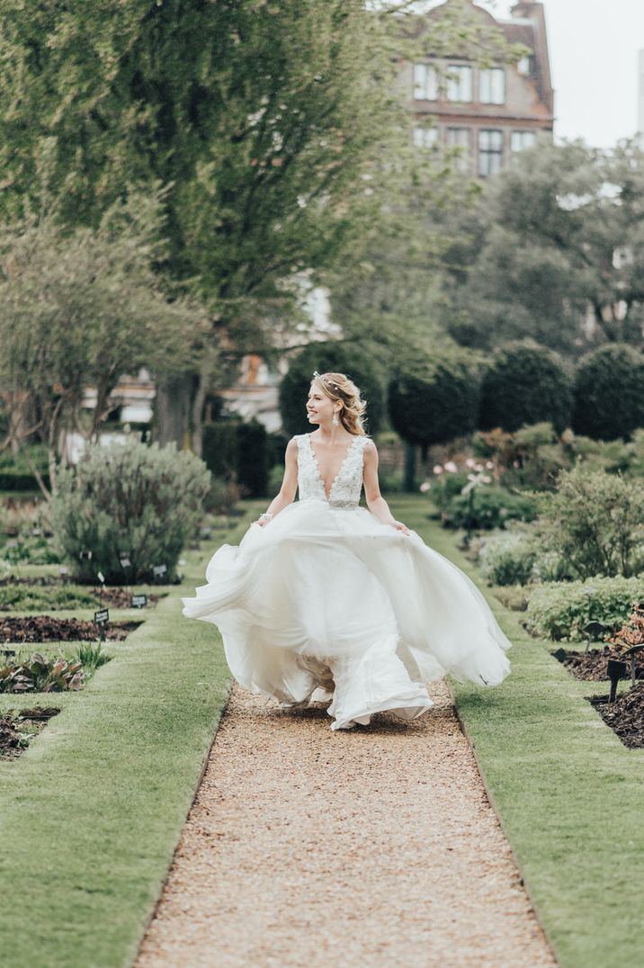 Deep v-neck plunge neckline embroidered princess wedding dress with flowing skirt by Rebecca Carpenter Photography