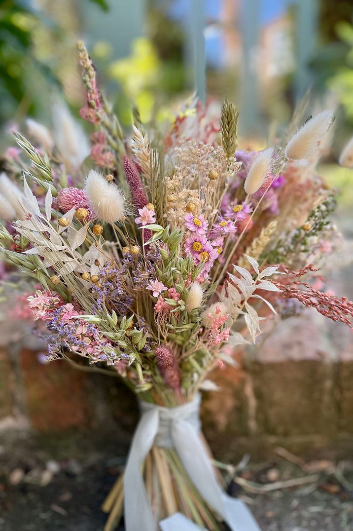 Bunny grass and pink dried wedding flowers making up a beautiful bouquet designed by Belvoir Flower Studio 