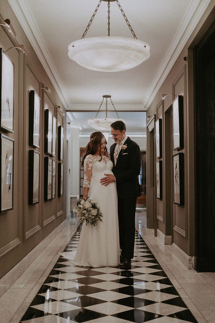 Claridge's hotel wedding venue with the bride and groom posing for their couple portrait 