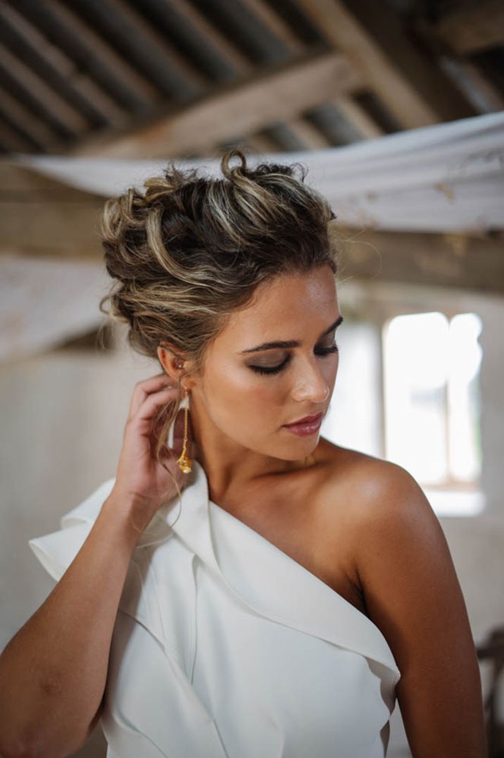 Bride in natural wedding makeup, bridal undo and dangly gold earrings 