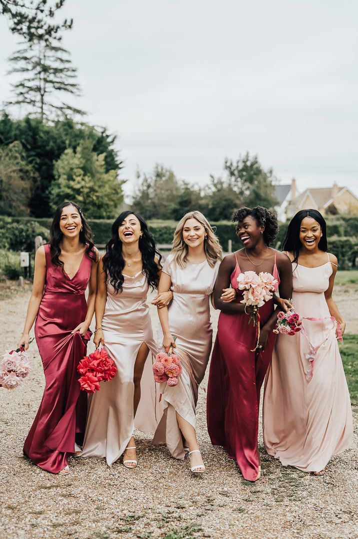 Bridesmaids wearing mismatched light and hot pink bridesmaid dresses for pink colour scheme wedding