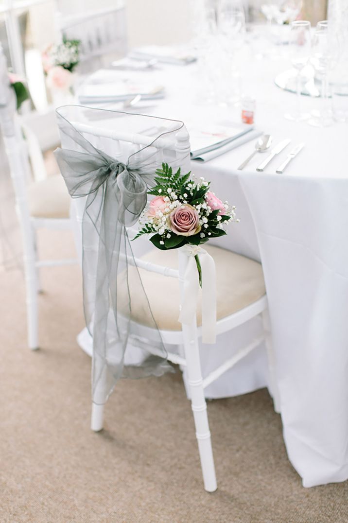 Light grey wedding chair decor with pink roses and white gypsophila floral decoration