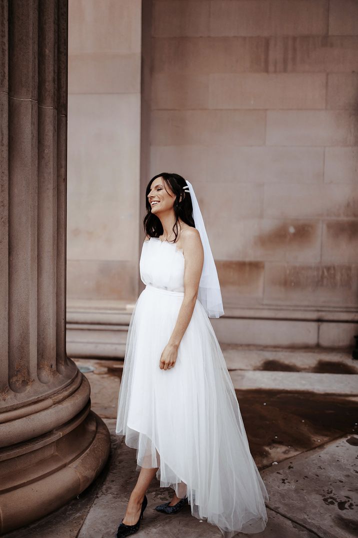 Bride wearing fingertip wedding veil with strapless maternity wedding dress 