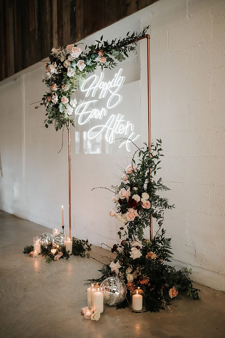 White 'Happily Ever After' wedding sign with foliage decor 