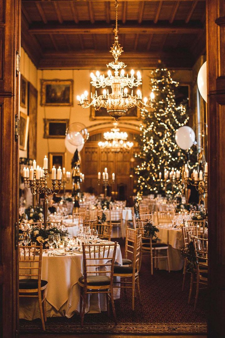 Christmas winter wedding with a Christmas tree, chandelier and black and gold colour scheme 