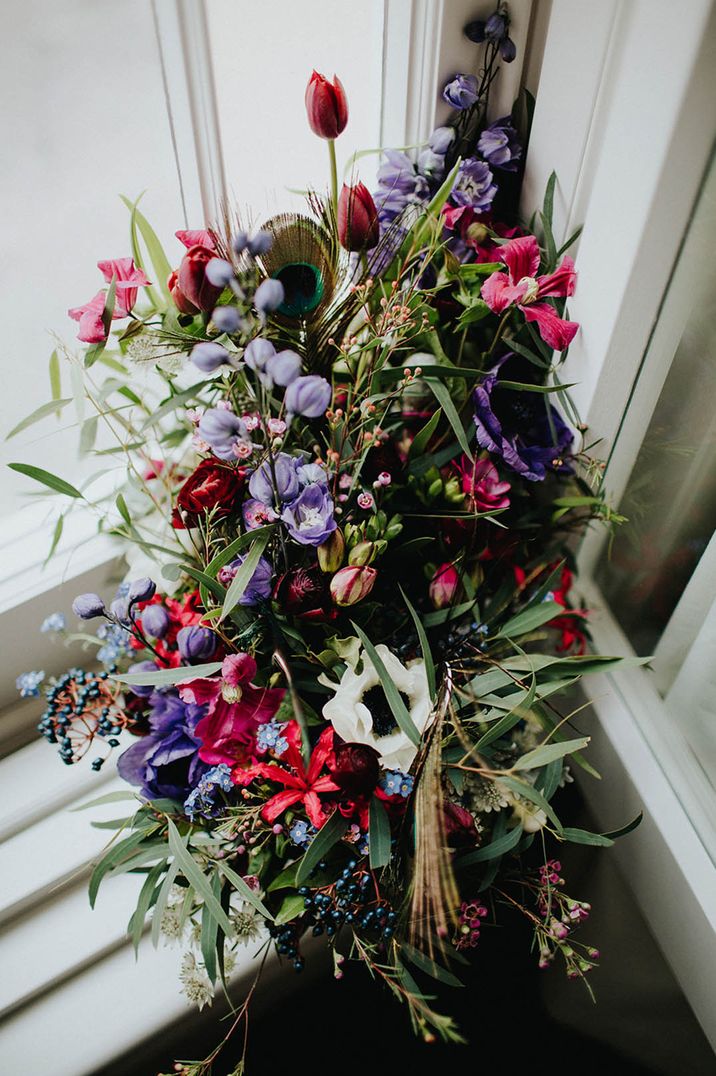 Purple, pink and white flowers with peacock feather 