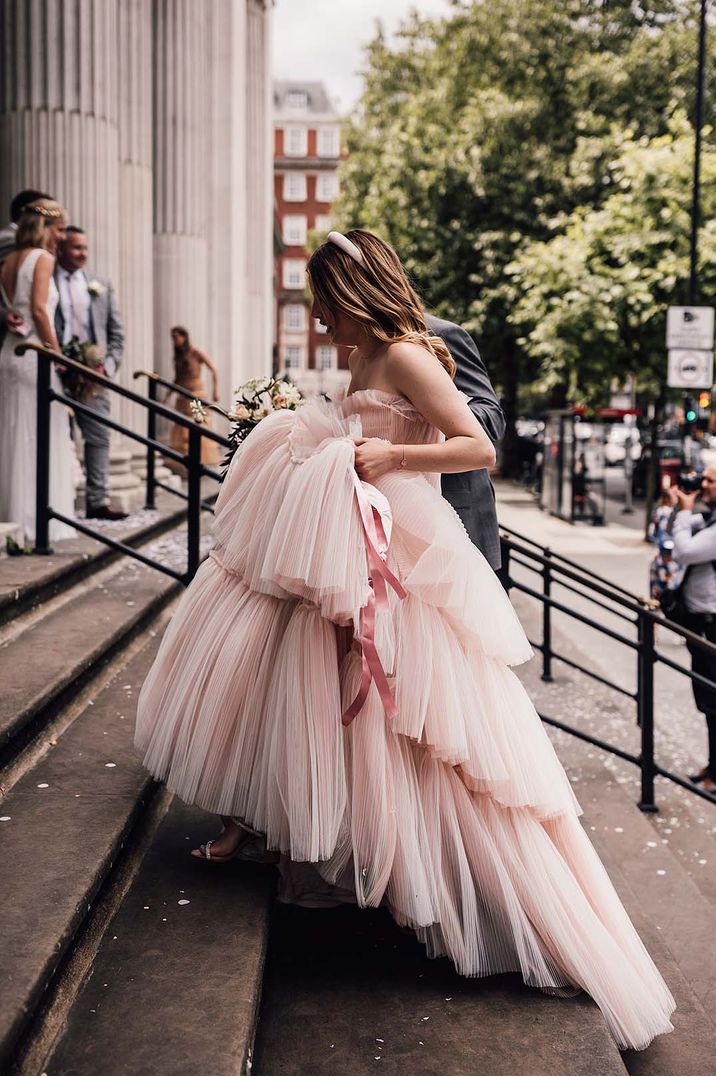 Bride in a bespoke blush pink wedding dress