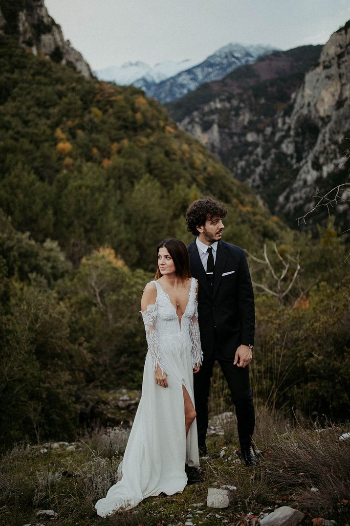 Bride in plunging lace wedding dress with cold shoulder style sleeves perfect for winter brides 