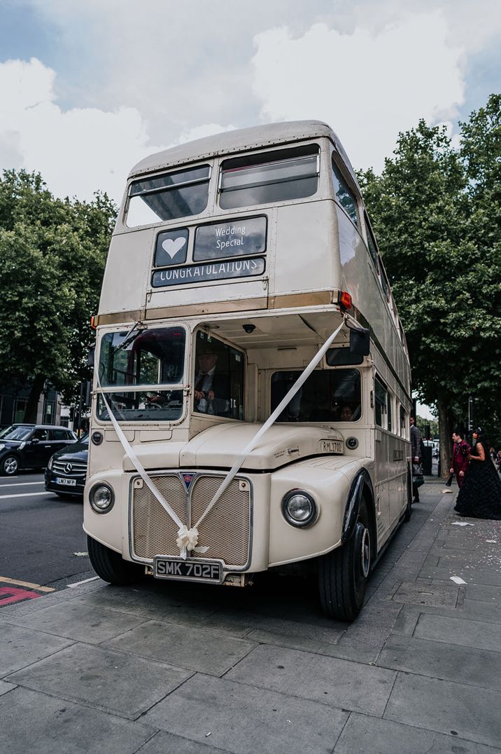 White retro double decker bus with white ribbon 