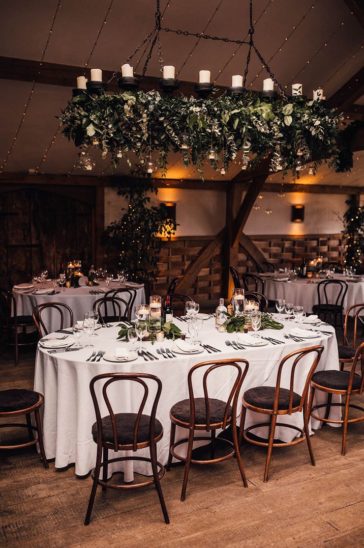 Winter wedding venue with table covered with a white table cloth with floating tea light table centrepieces 