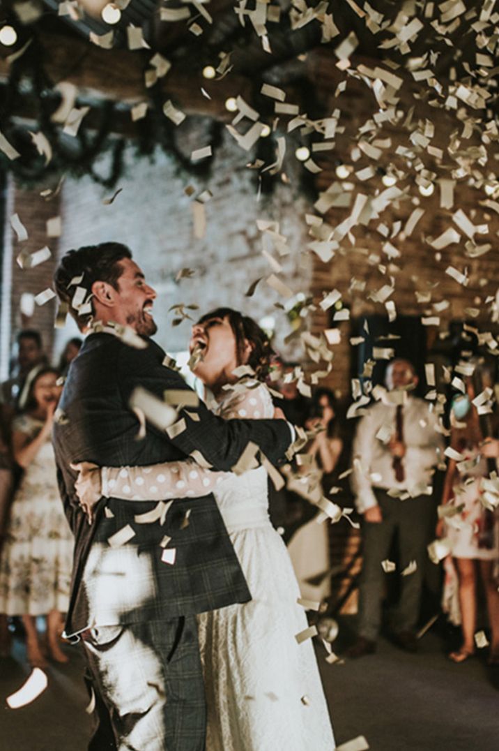 Gold confetti explodes around the couple as they participate in their first dance together 