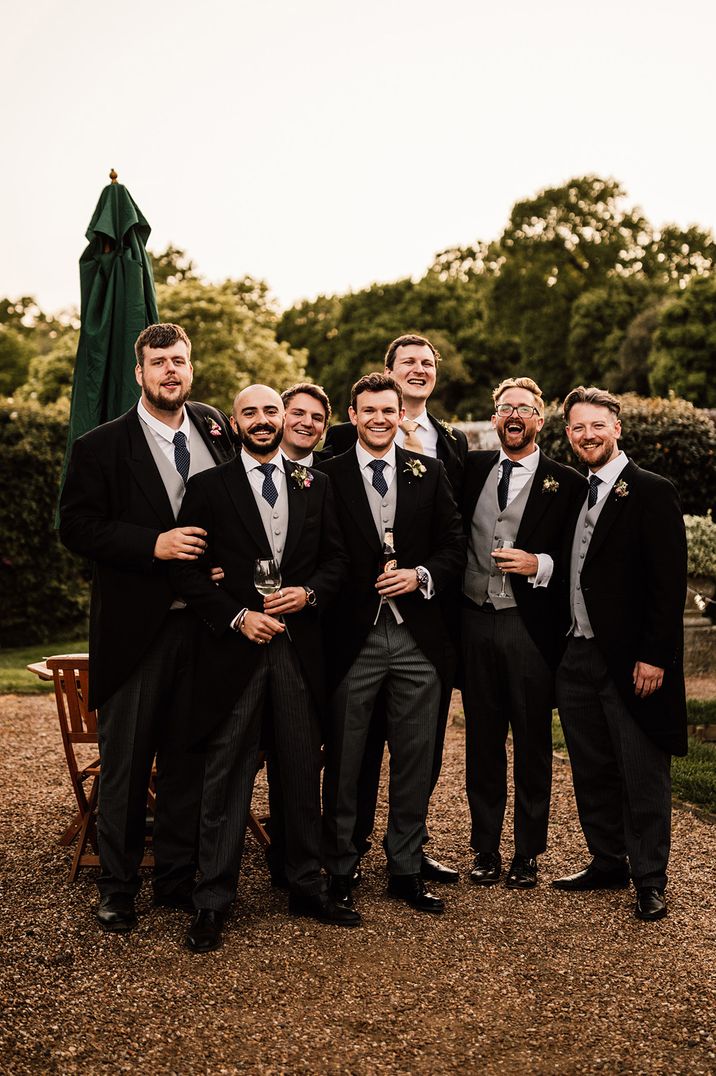 Groomsmen wearing black wedding suits by Carrie Lavers Photography