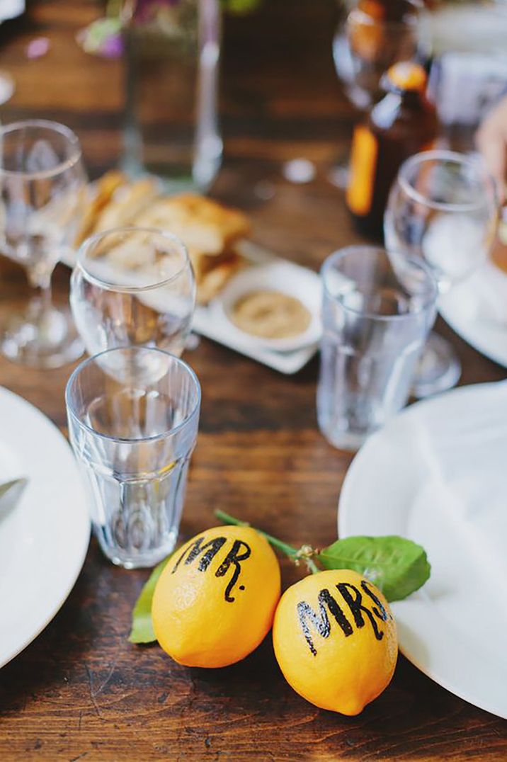 Wedding table decor with Mr and Mrs painted on lemons by Jonathan Ong Photography