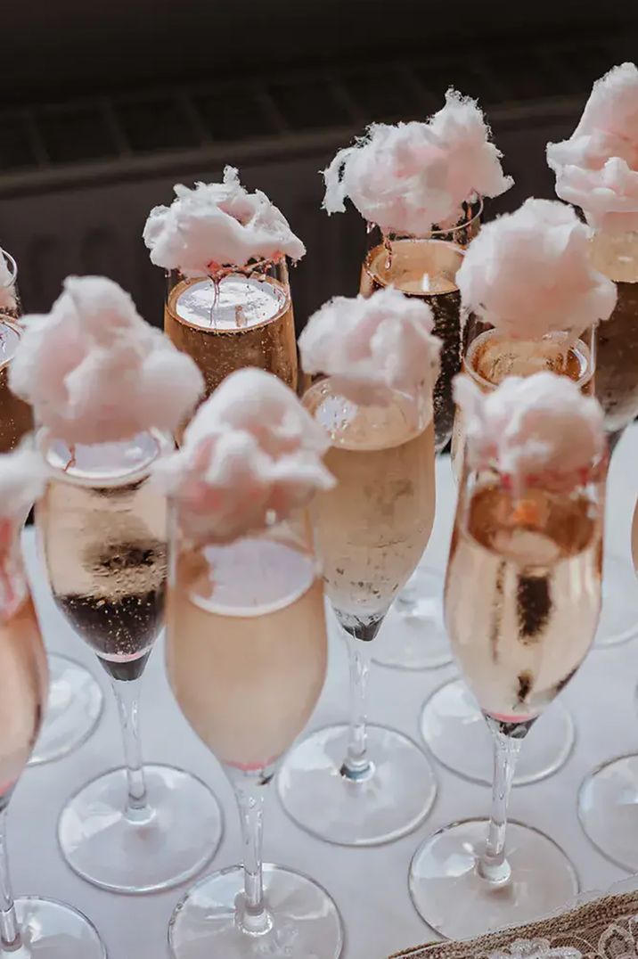 Rose-coloured prosecco with candy floss at the top by Cat Stephens Photography