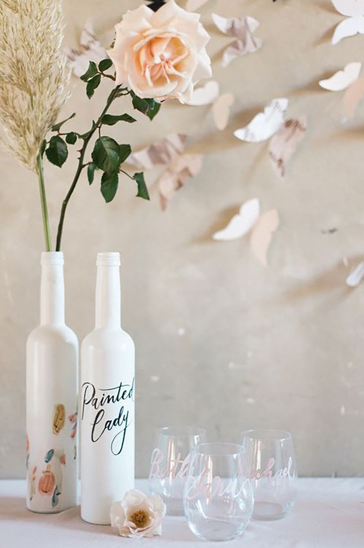 Butterfly wedding decor with flowers, glasses and 3d butterflies on the wall by Marion Heurteboust Photography