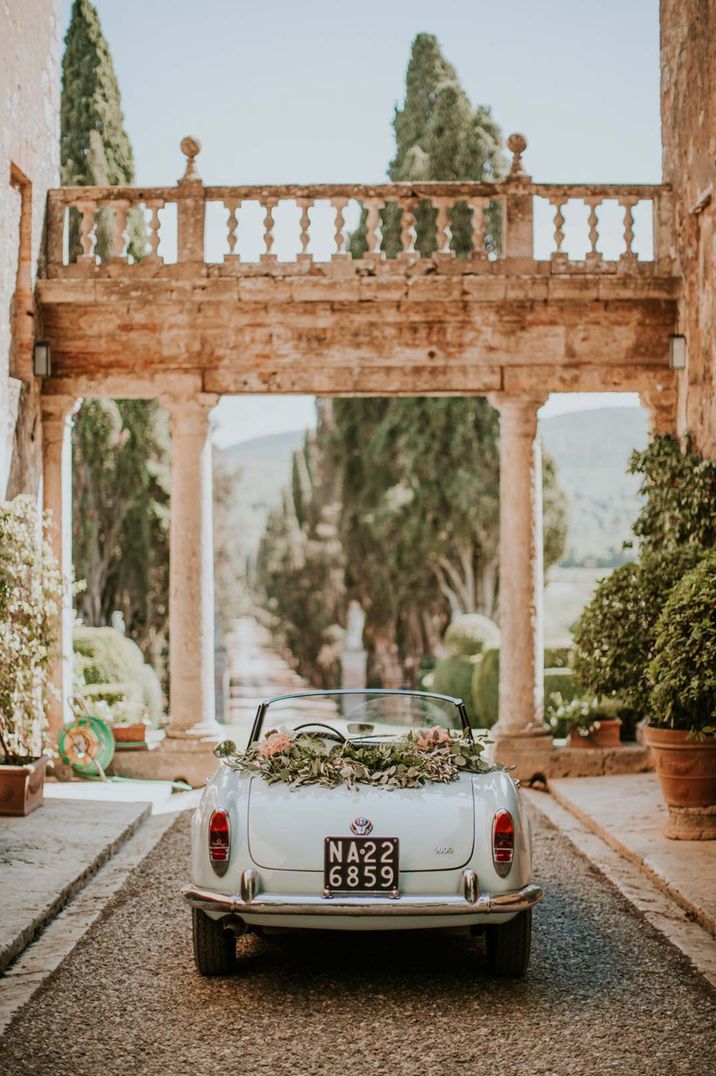 Light blue convertible wedding car with floral decorations