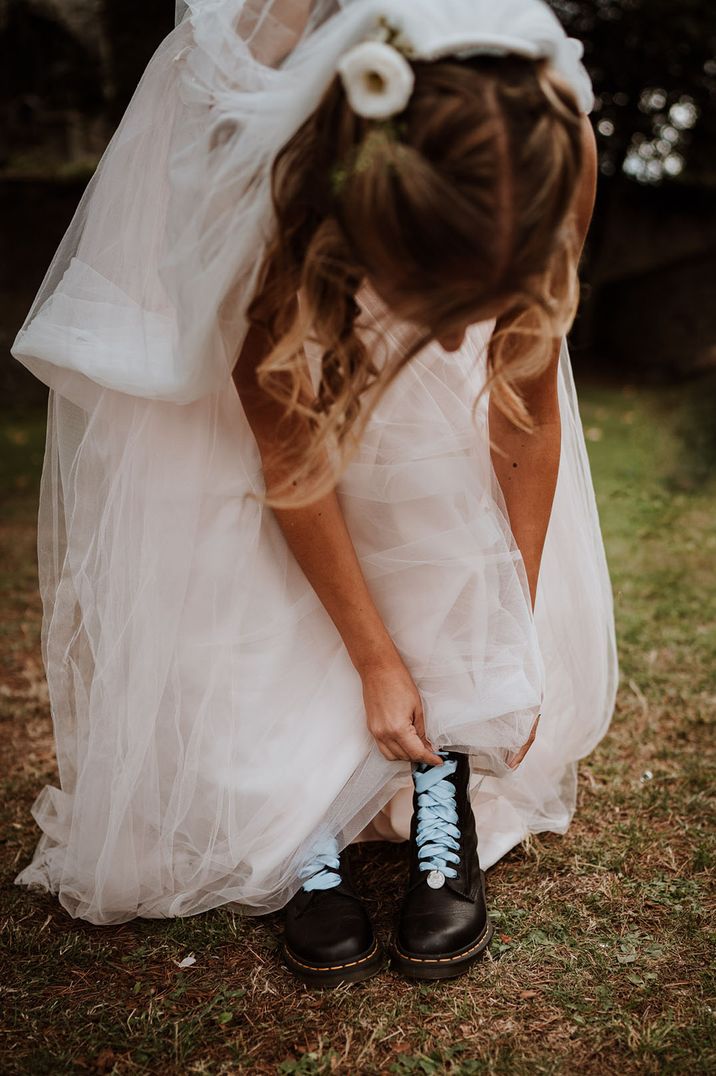 Bride wears Dr Martens with blue ribbon laces 