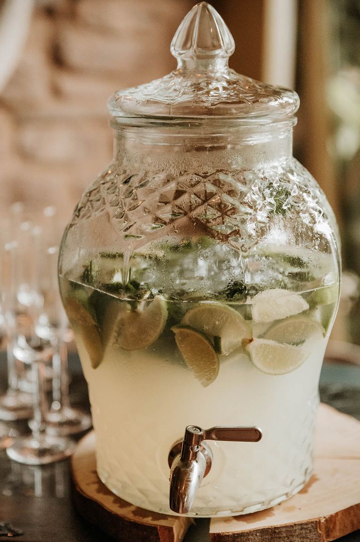 Lime fruit wedges inside a glass wedding drink dispenser 