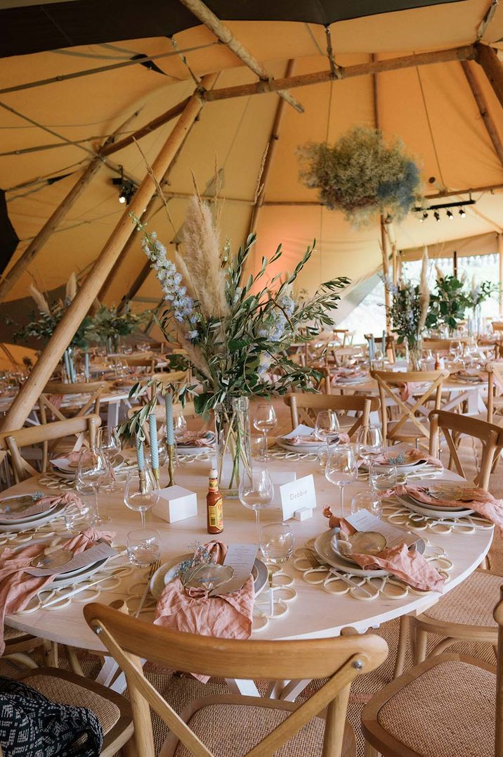 Buffalo Tipi wedding tipi with pastel table setting with baby blue candles and pink napkins 