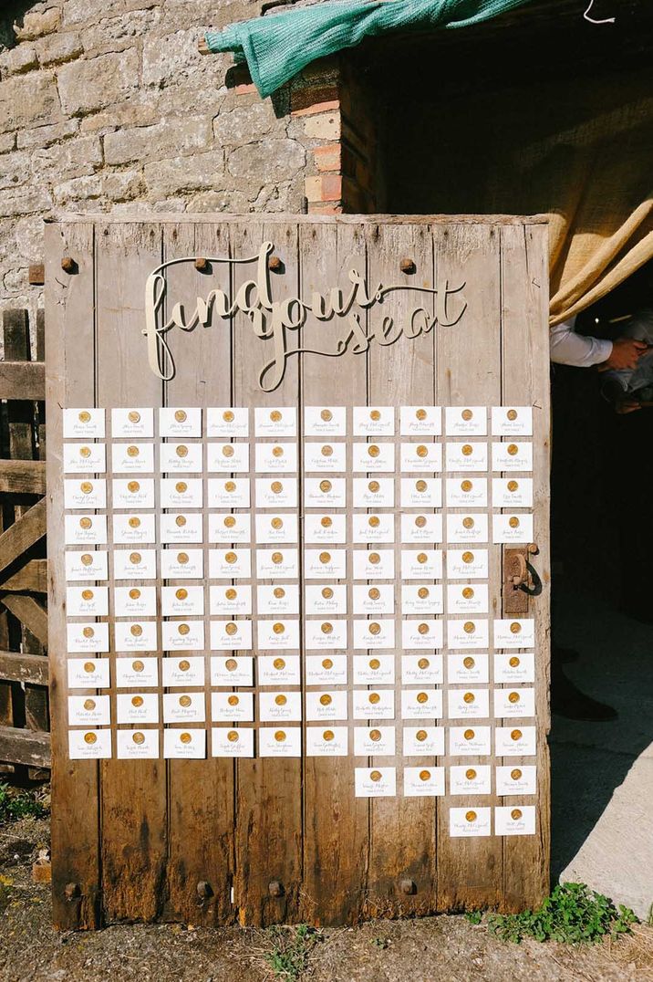 Large wooden door seating plan with gold wax seals 