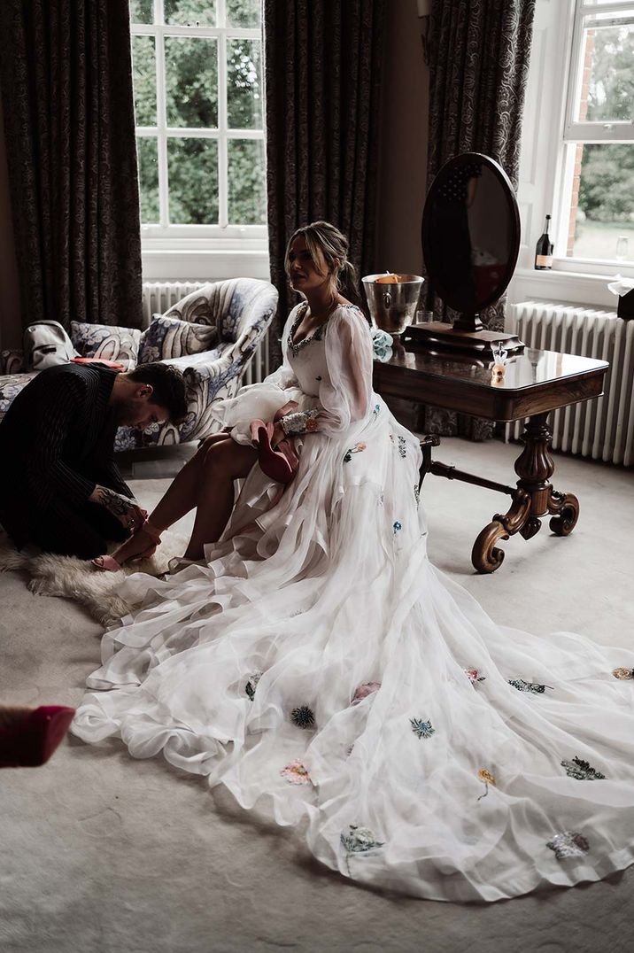 Bride in Victoria Sanders wedding dress with appliqué floral details