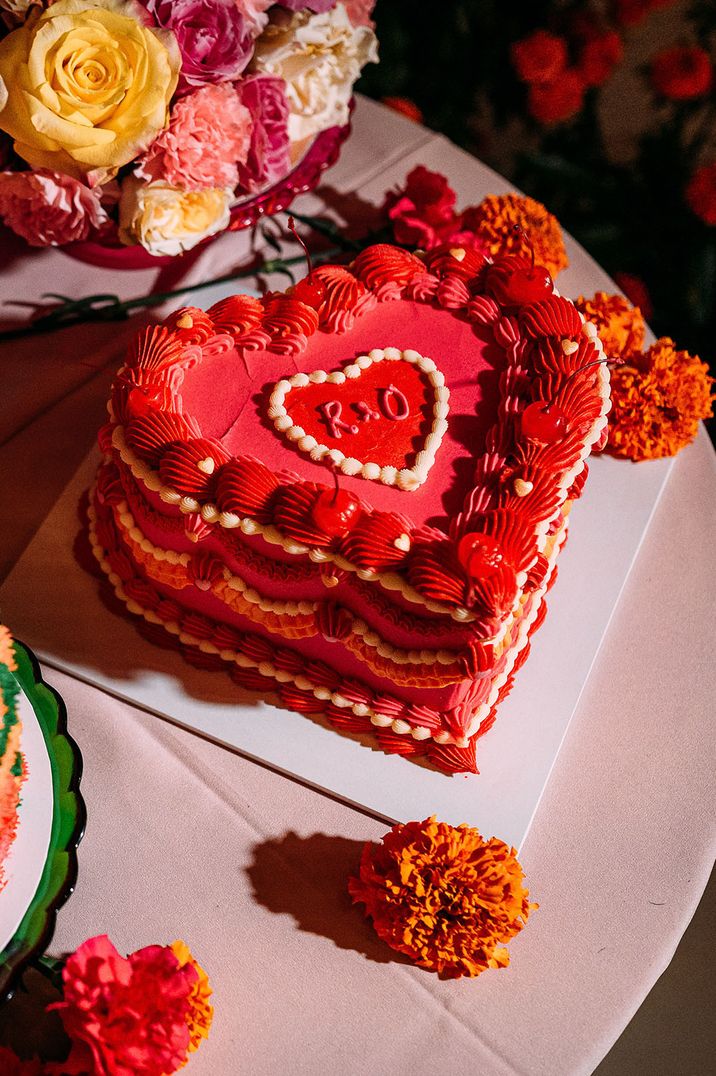 Heart shaped bright pink and orange frosted retro wedding cake for summer glasshouse wedding 