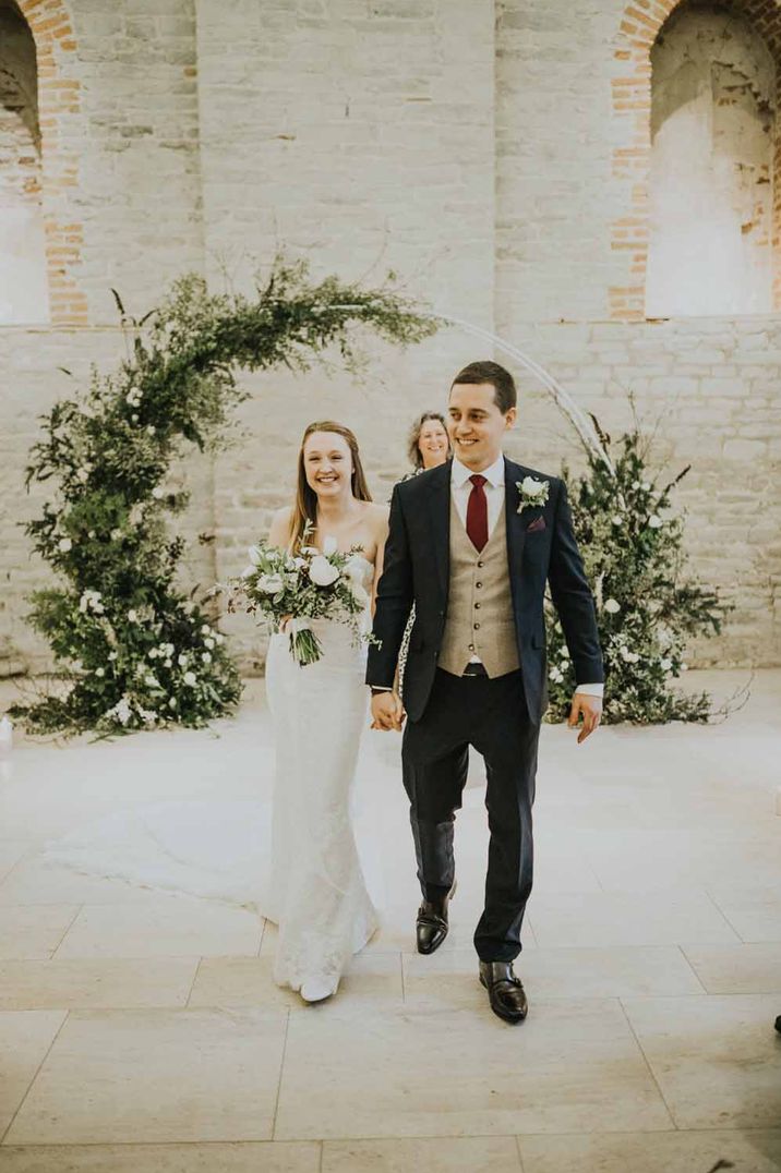 Large green floral arch and winter bouquet by wedding florist Miranda Hackett Flowers