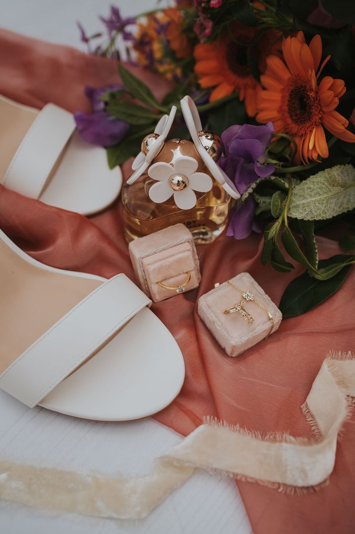 Marc Jacobs Daisy perfume beside bridal jewellery and white heels 