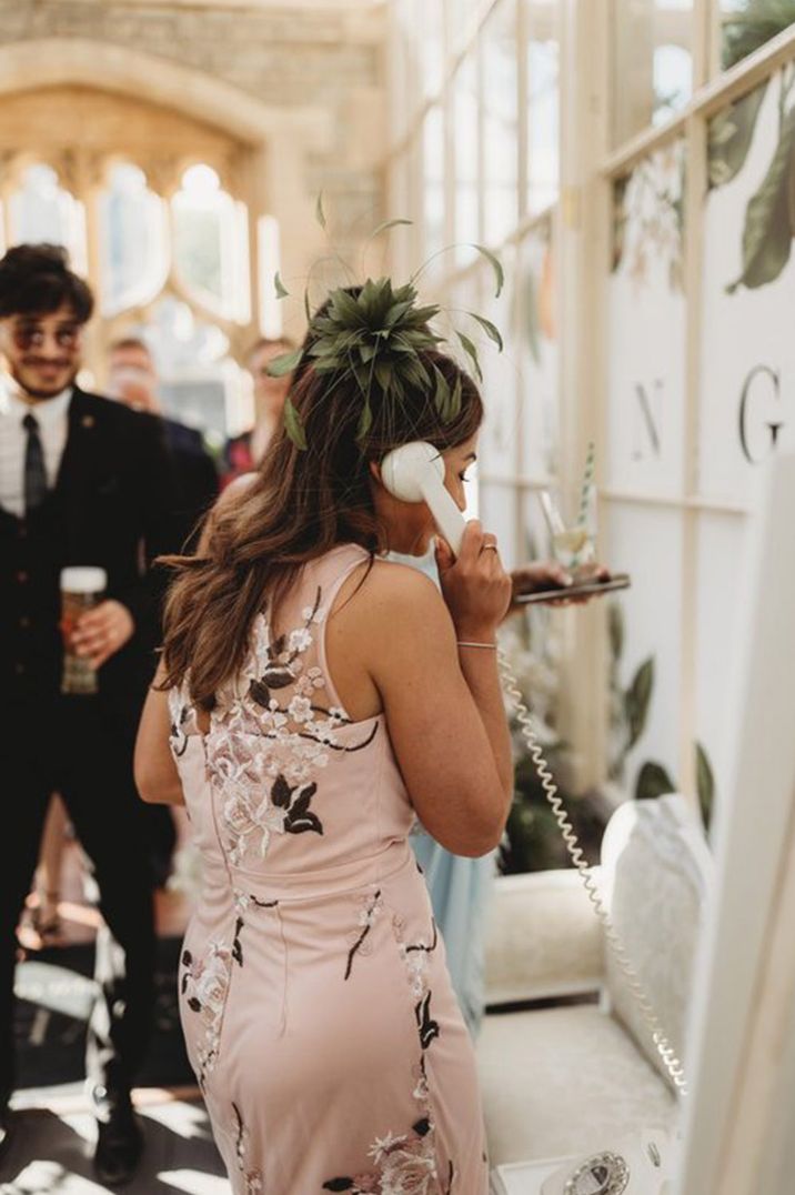 wedding guest leaving an audio message on a retro telephone alternative guest book