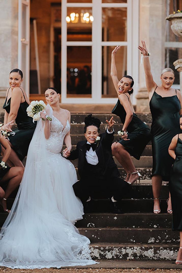 LGBTQI+ wedding with the bridesmaids in cowl neck black satin midi bridesmaid dresses 