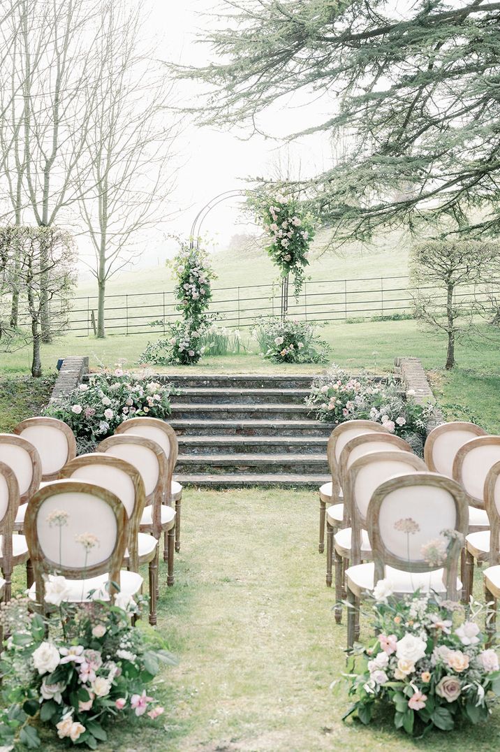 Outdoor wedding ceremony with white wedding flowers 