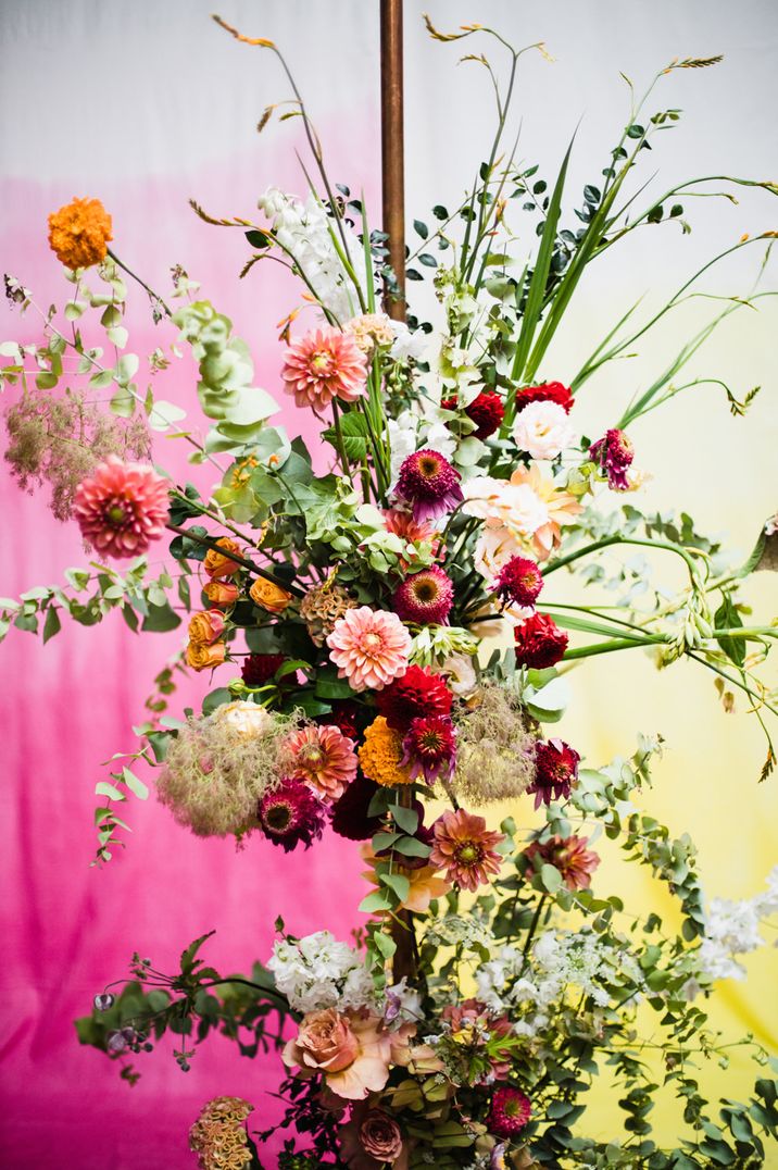 Colourful wedding flower arrangement with dahlias, roses, stocks and foliage 