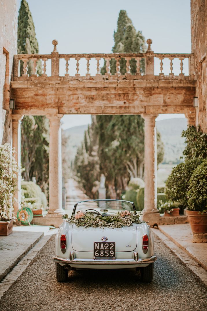 Light blue convertible wedding car with floral decorations