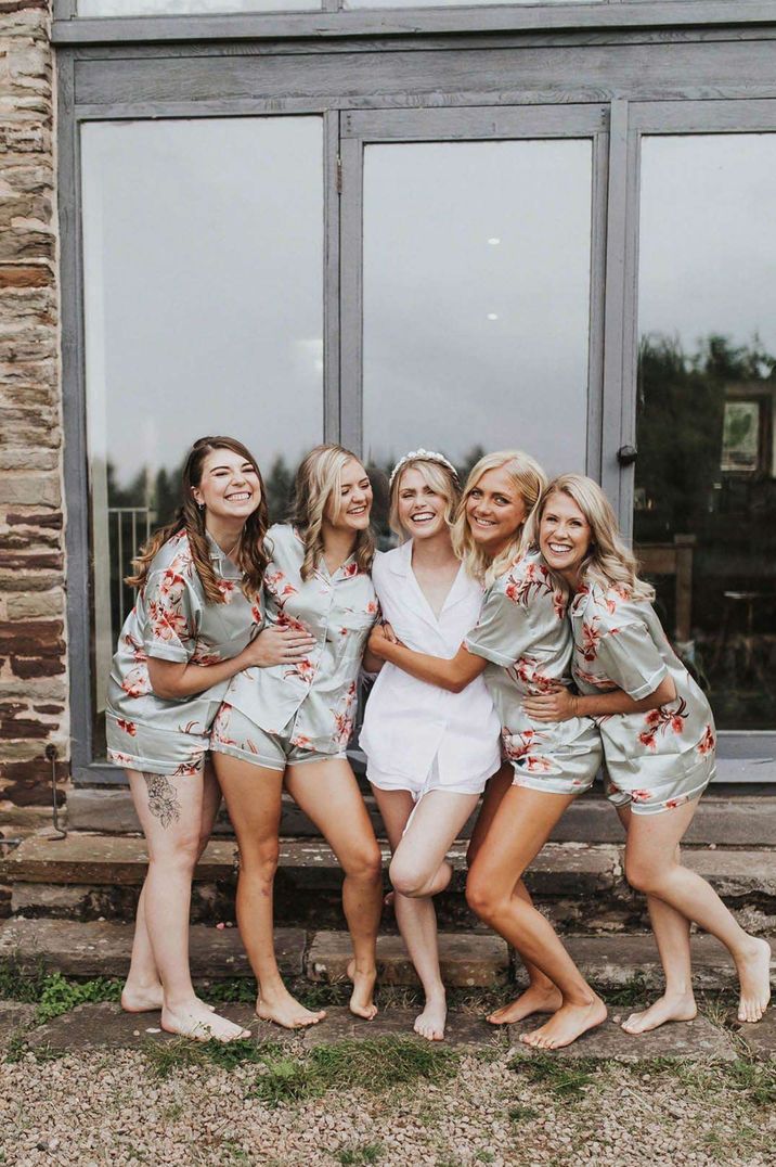 Bride and bridal party in wedding getting ready silk pyjamas posing before wedding 