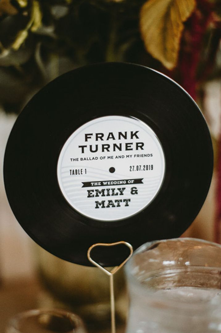 Personalised vinyl record table name sign with the couple's favourite songs, their name and wedding date 