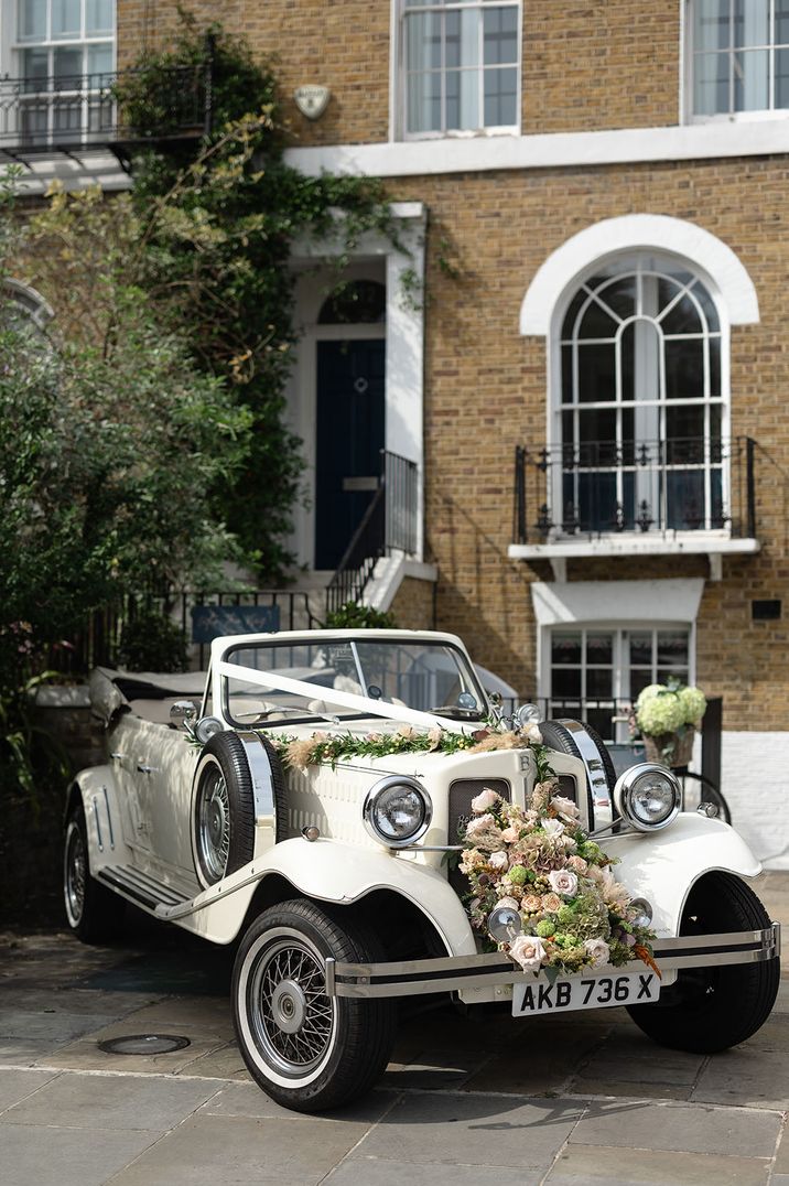 AB Chauffeurs wedding car decorated with romantic neural wedding flowers from SW Blooms 