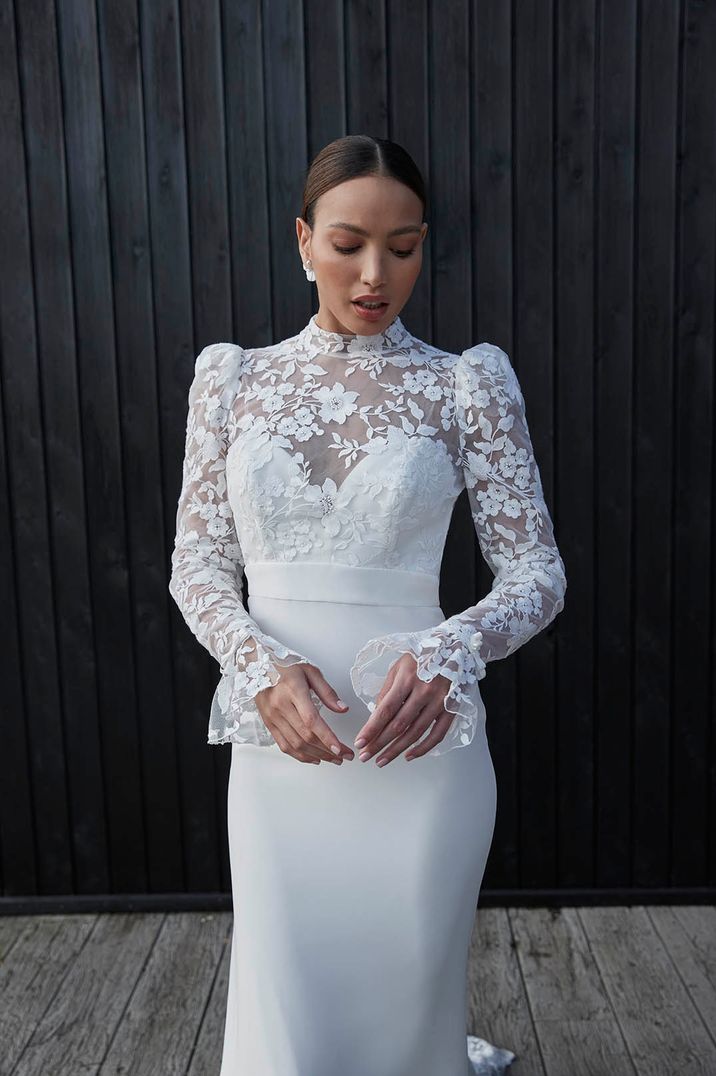 Bride in wedding dress with lace long sleeve and shoulder pads for traditional wedding look 